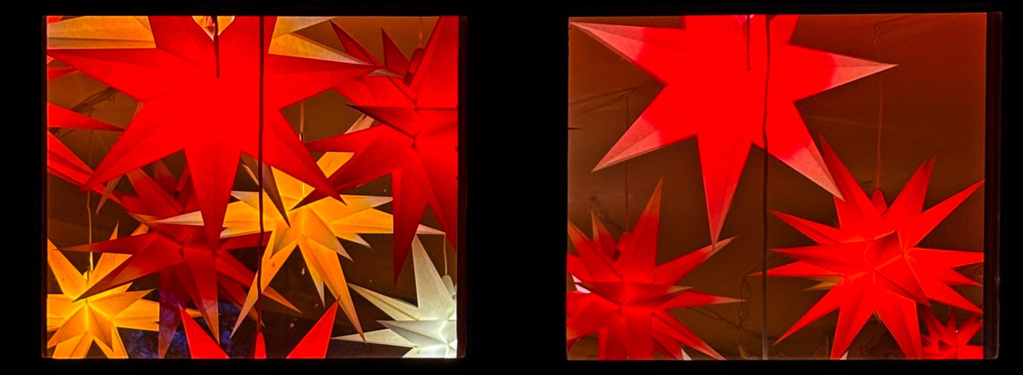 Fenster mit leuchtenen Papiersternen dahinter